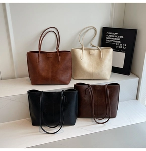 Modern tote bags in brown, beige, black and coffee colors displayed on white steps