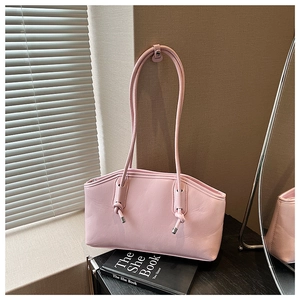 Pink leather shoulder bag with stylish knotted strap detail and silver hardware accents