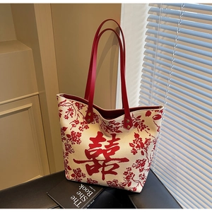 Detail of red bridal double happiness print and faux leather handles on canvas tote bag