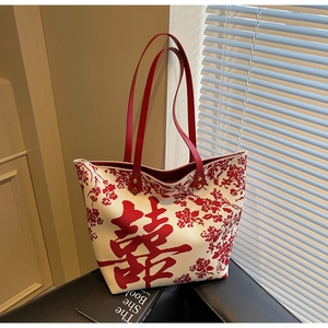 Detail of canvas tote bag featuring red double happiness character and floral patterns