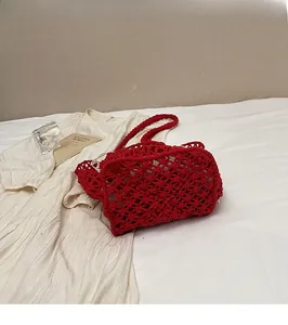 Macro detail of red Macrame knit tote bag with woven mesh texture and white drawstring liner