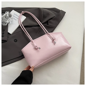 Pink glossy faux leather tote bag featuring elegant knotted straps and silver metal hardware