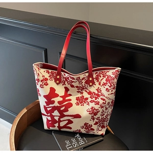 Detail of Chinese wedding tote bag with red Xi character and floral jacquard pattern