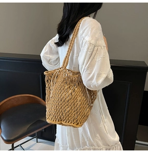 Detail of hand-woven hollow knit tote bag with mesh texture and white drawstring pouch