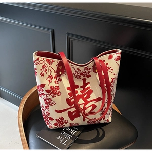 Close-up of red floral jacquard on white canvas tote bag with traditional Xi character