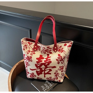 Macro detail of the Chinese wedding tote bag with red Xi character and floral patterns