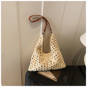 Detail view of cream crochet knit tote bag with premium brown leather shoulder strap