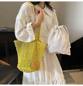 Detail of yellow hollow knit tote bag with a removable linen drawstring inner pouch