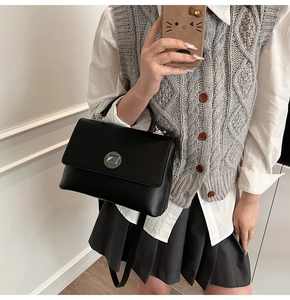 Mirror selfie showing the black leather crossbody bag size and practical wearing style