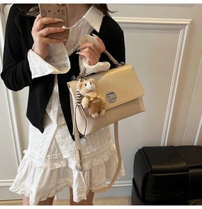 Chic beige crossbody bag with metal buckle and cute teddy bear plush charm detail