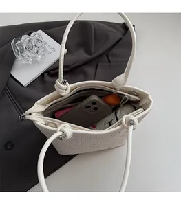 Top view of woven cream tote bag showing spacious interior with zipper pocket and lining
