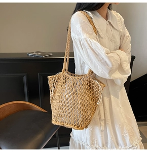 Detail of hollow knit tote bag featuring beige crochet texture and white drawstring pouch