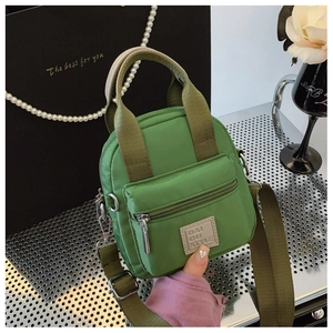 Waterproof green nylon mini crossbody bag with top handles and adjustable strap