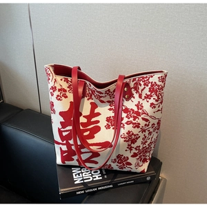 Detail of red floral embroidery and Double Happiness symbol on canvas tote bag