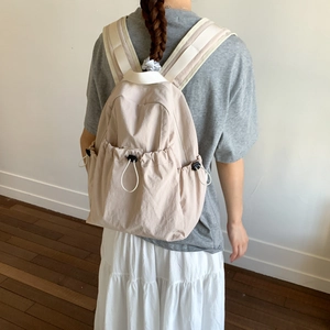 Close-up of lightweight nylon backpack with drawstring pocket and wide shoulder straps