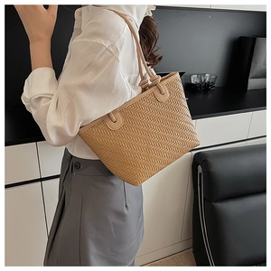 Detail showing the intricate woven texture and high-quality synthetic leather of the tote bag
