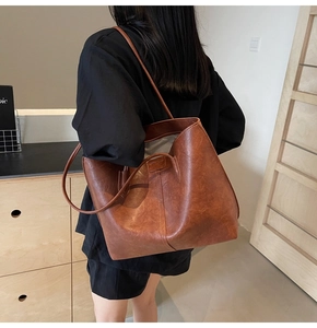 Model view showing the large vintage brown leather tote bag with retro textured finish