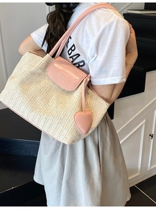 Handmade woven straw tote bag with pink leather straps and heart charm for summer beach
