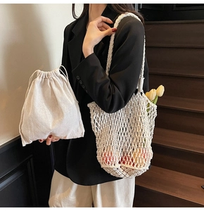 Detail of white crochet tote bag showing woven rope texture and drawstring inner pouch