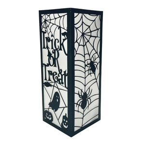 Detail of Halloween Trick or Treat hollowed black lantern with spider web and pumpkin patterns