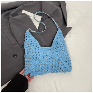 Détail du tissage ajouré d'un sac hobo bleu clair avec bandoulière fine en cuir