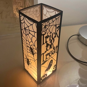 Halloween castle lantern with spider web and hollow Trick or Treat design and warm glow