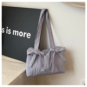 Macro shot of pleated lavender fabric with bow knot decoration on an oxford tote bag