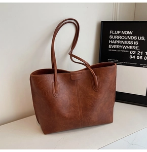 Close-up of brown vintage tote bag with premium leather texture and vertical stitching