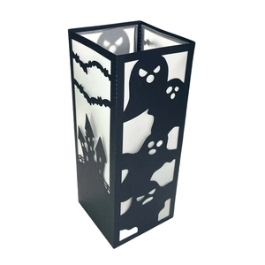 Detail view of black laser-cut hollow paper lampshade with Halloween castle and ghost motifs