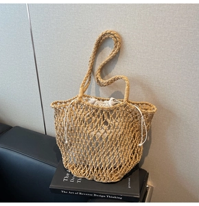 Macro shot of hand-woven hollow knit tote with natural straw texture and drawstring liner