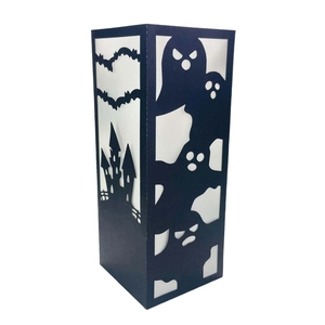 Detailed laser-cut Halloween candle sleeve featuring bats, ghosts, and a gothic castle