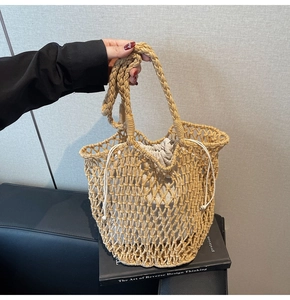 Close-up of hollow mesh knit tote with braided handles and drawstring inner pouch