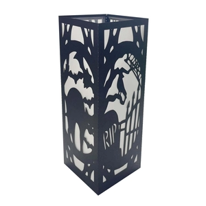 Detail of square black laser-cut lantern with Halloween bat and cemetery motif