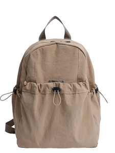 Lightweight khaki nylon backpack with large front pocket and adjustable drawstrings