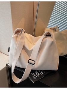 Minimalist beige corduroy tote bag with adjustable strap shown in a modern interior setting