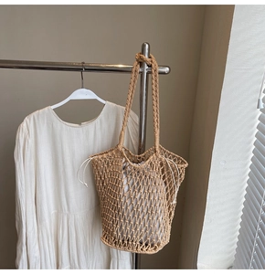 Close-up of bohemian hollow knit tote bag with a white drawstring inner pouch