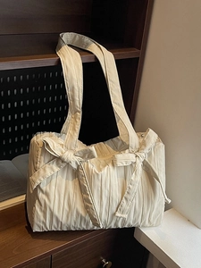 Chic pleated nylon tote bag in cream white featuring elegant decorative front bows