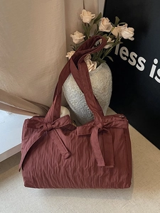 Brownish red pleated nylon tote bag with decorative bows and zipper closure for women