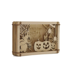 Detail view of multi-layer laser-cut wooden Halloween shadow box with witch and pumpkin
