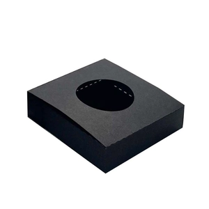 Detail view of square black paper gift box with a circular cutout top for candle lighting