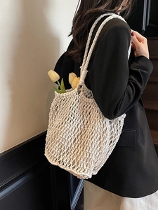 White hand-woven hollow knit tote bag for beach vacations and casual summer fashion