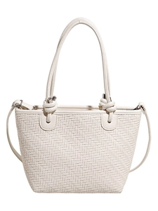 Chic cream woven tote bag with knotted handles and crossbody strap on white background