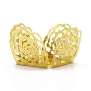 Detail of rose gold mirror finish hollow lace cupcake wrappers for weddings and parties
