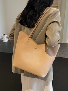 Minimalist beige pebble leather tote bag with long shoulder straps for daily use