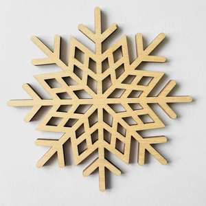 Detailed laser-cut snowflake wooden coaster featuring natural wood grain and hollow pattern