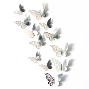 Macro view of 3D silver laser-cut butterfly wall stickers with mirrored metallic texture