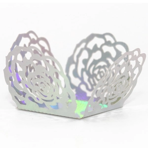 Close-up of laser-cut rose hollow cupcake wrapper with iridescent metallic finish