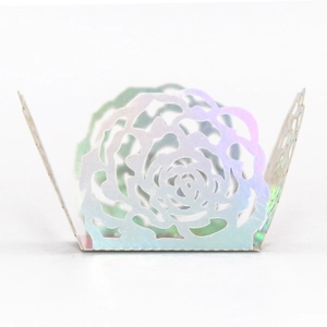 Macro detail of laser-cut rose pattern on iridescent rainbow candy box decoration