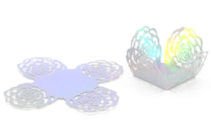 Macro detail of laser-cut rose hollow candy box with iridescent mirror finish paper