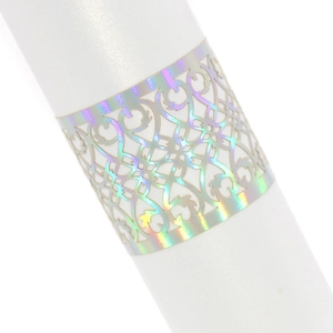Detailed view of iridescent laser-cut hollow napkin ring with holographic finish for weddings